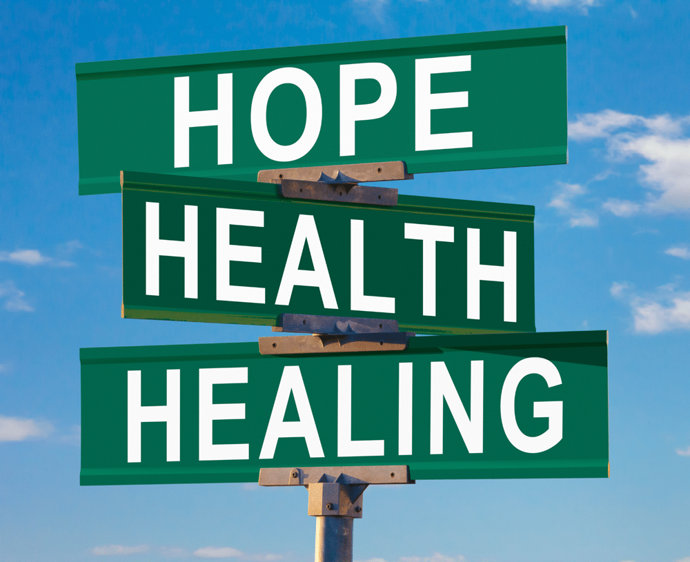 A sky-blue background with three green street signs reading "Hope," "Health," and "Healing," each stacked one on top of the other, symbolizing vital resources for a brighter future.